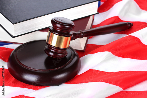 Photo: judge gavel and books on american flag background judge gavel and books on american flag background