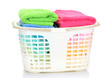 Plastic basket with bright towels isolated on white