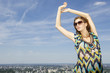 beautiful girl in sunglasses on background blue sky