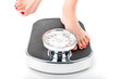 Young woman standing on a scale