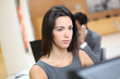 Woman working in office in front of desktop computer