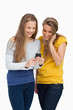 canvas print picture - Two females student smiling while looking a cellphone
