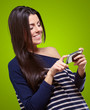 portrait of young woman touching a modern mobile over green