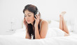 Photo: Woman holding her headphones while listening to music with her e Woman holding her headphones while listening to music with her e