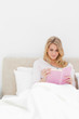 Closer shot, Woman reading her book while sitting in bed