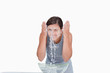 Young woman washing her face with a splash of water