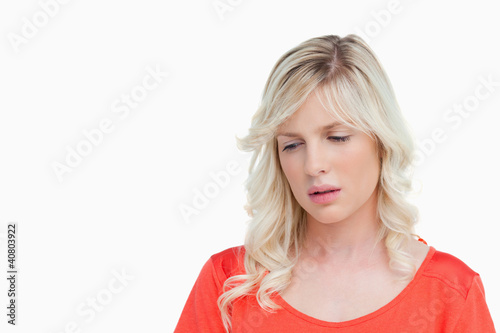 Foto: Sad woman standing upright while looking down Sad woman standing upright while looking down