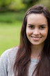 canvas print picture - Young attractive woman looking straight at the camera while stan