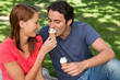 Photo: Woman feeding her friend ice cream Woman feeding her friend ice cream