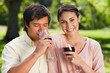 Woman smiling while her friend is drinking wine