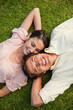 Woman looking at her friend while lying head to shoulder with hi