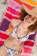 Overhead view of an attractive woman in bikini holding an orange Overhead view of an attractive woman in bikini holding an orange