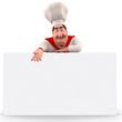 Smiling chef pointing towards sign