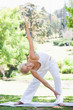 Photo: Woman doing warm up exercises in the park Woman doing warm up exercises in the park
