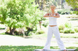 Woman doing yoga exercises outdoors