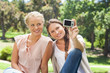 Photo: Friends taking picture of themselves with a camera Friends taking picture of themselves with a camera