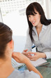 Photo: The smiling business lady chats with a fellow employee The smiling business lady chats with a fellow employee
