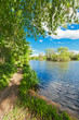 Narrow path through the wood by the shore of the lake