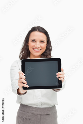 Photo: Portrait of a brunette showing a touchpad screen Portrait of a brunette showing a touchpad screen