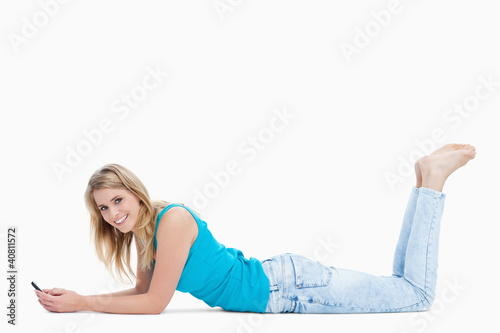 Photo: A woman lying on the floor with her legs held up is holding her A woman lying on the floor with her legs held up is holding her