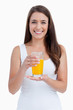 Smiling woman holding a glass of orange juice