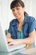 canvas print picture - Portrait of a female student doing her homework with music