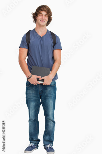 Foto: Male student posing with a backpack and books Male student posing with a backpack and books