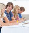 Close up of a smiling student with friends looking at the camera