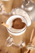 coffee latte with cinnamon sticks and cacao heart , shallow dof