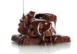 Slices of milk and dark chocolate bar poured chocolate isolated