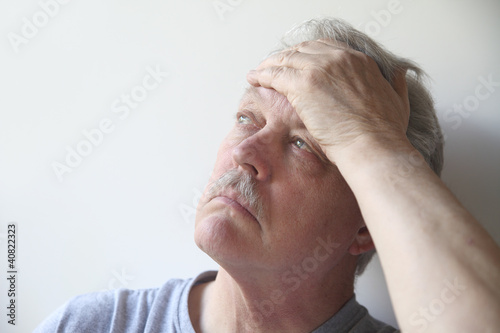 Photo: older man with a bad headache older man with a bad headache