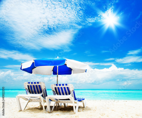Photo: Vacation and Tourism concept. Sunbed on the beach Vacation and Tourism concept. Sunbed on the beach