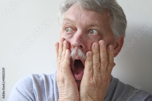 Photo: senior man is horrified and fearful senior man is horrified and fearful