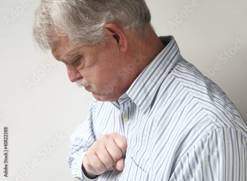 Photo: senior man suffers from bad heartburn senior man suffers from bad heartburn