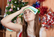 Woman in christmas hat having hangover