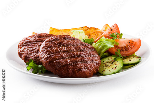 Photo: Grilled beefsteaks, baked potatoes and vegetable salad Grilled beefsteaks, baked potatoes and vegetable salad