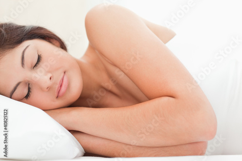 Photo: A close up view of a woman sleeping with her head on the pillow A close up view of a woman sleeping with her head on the pillow