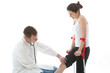 Orthopaedic surgeon examining the knee of a female patient