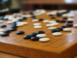 White and black counters thrown on a board. Renju.