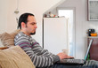 Young man with laptop at home