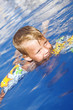 Little boy in pool water Little boy in pool water