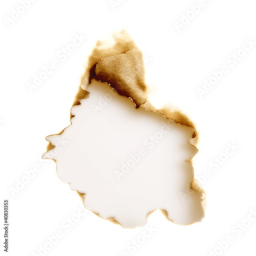 Photo: burnt hole in a white sheet of paper burnt hole in a white sheet of paper