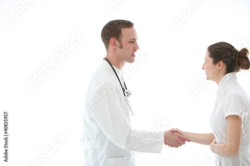 Photo: Doctor shaking a colleague's hand in greeting Doctor shaking a colleague's hand in greeting