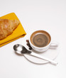 A cup of coffee with croissant