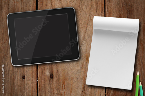 Photo: workspace with tablet pc. and note paper. workspace with tablet pc. and note paper.