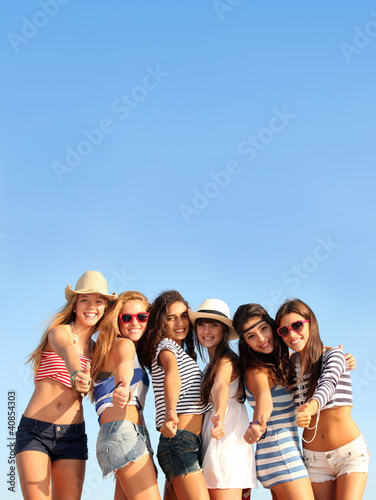 Photo: group of teens on beach summer vacation or spring break group of teens on beach summer vacation or spring break
