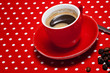 A red cup of coffee on red background