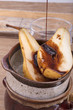 melted chocolate running over a fresh halved pear.