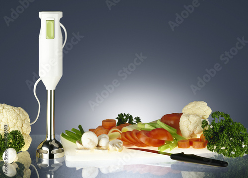 Photo: fresh vegetables and electrical blender fresh vegetables and electrical blender