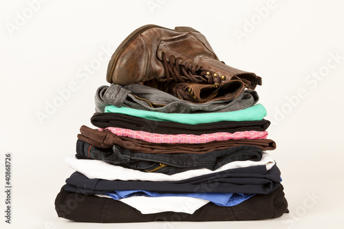 Photo: Pile Of Old Clothes And A Pair Of Boots Pile Of Old Clothes And A Pair Of Boots